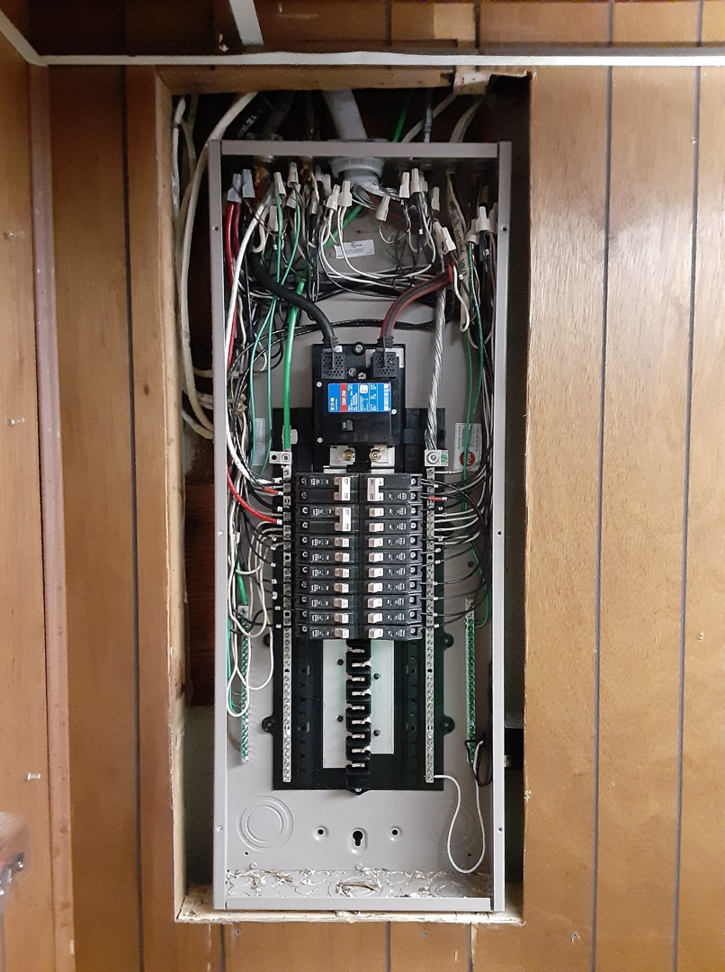 A newly installed electrical panel with wiring in a residential wall by RTJ Electrical in Allentown, PA