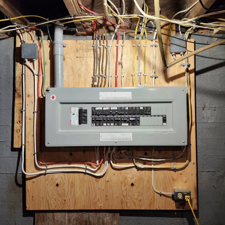 A new electrical panel with circuit breakers and organized wiring, professionally installed by SEL Electric in Truro, NS.