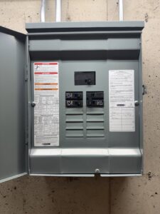 A newly installed electrical panel on a concrete wall by Swartz Electric in Colorado Springs, CO.