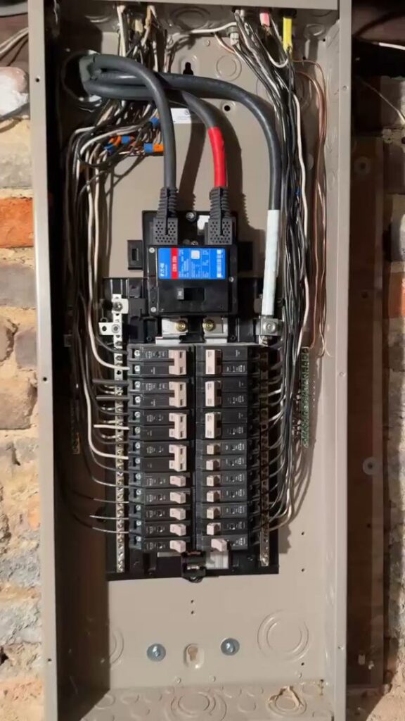 A newly installed electrical panel with organized wiring and breakers by Mister Sparky of Greensboro in Greensboro, NC.