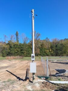 A new electrical pole and meter installation in a field by Elite Electrical TN in Jackson, TN.