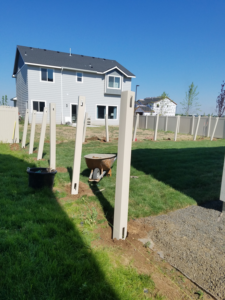 Newly installed fence posts set in the ground for a residential fencing project by Double A Fence LLC in Boise, ID.