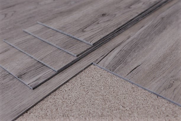 New wood-look flooring being installed next to existing carpet by JEMS Carpet Service in Rio Rancho, NM.