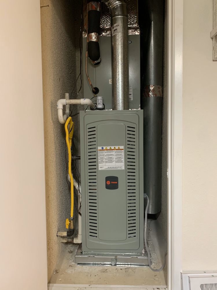 A new furnace and air handler unit installed in a utility closet by 20th Century Heating and Air in Anaheim, CA.