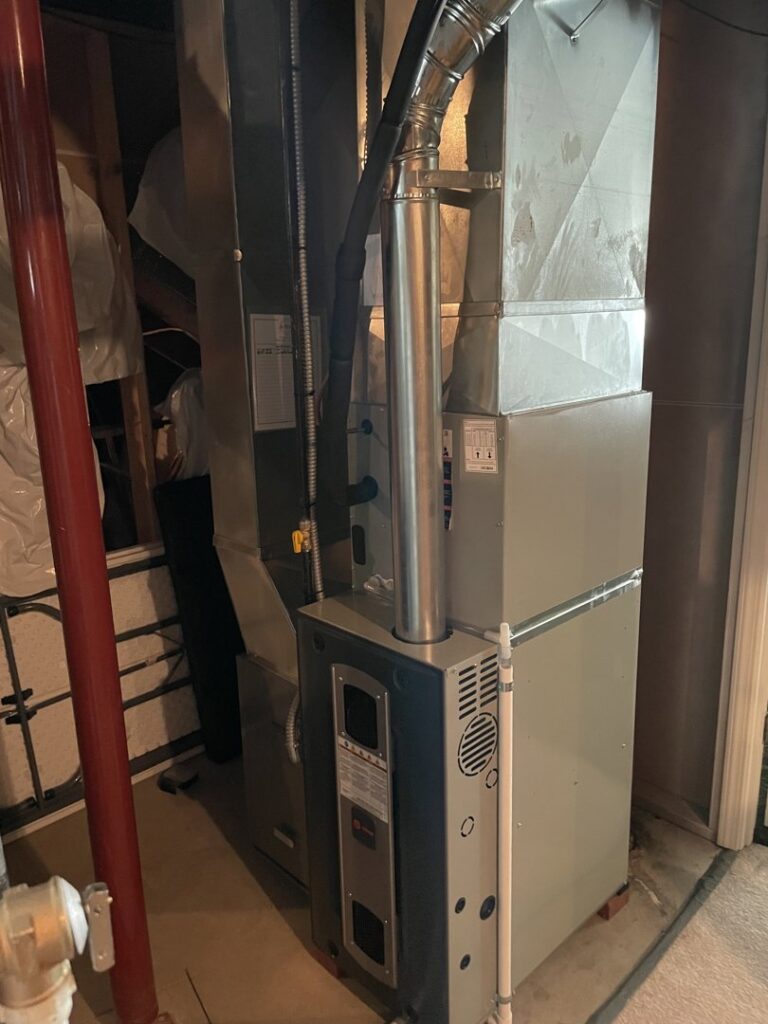 A new furnace and air handler unit with ductwork installed by A-Team PHC in Olathe, KS.