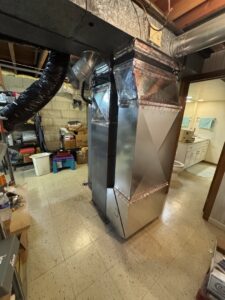 A new furnace and air handler unit with ductwork installed in a basement by HVAC KING LLC in Maple Grove, MN