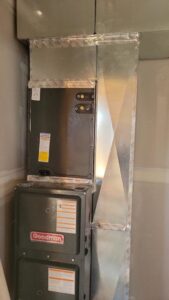 A new Goodman furnace and air handler unit with ductwork installed in a residential closet by Integrity Heating And Air LLC in Nampa, ID