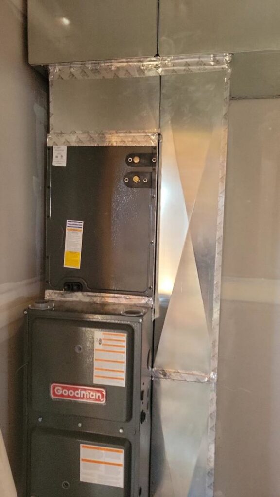 A new Goodman furnace and air handler unit with ductwork installed in a residential closet by Integrity Heating And Air LLC in Nampa, ID