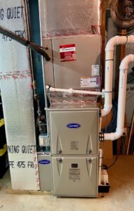 A newly installed Carrier furnace and air handler unit in a residential basement by JK Mechanical in Willow Street, PA.