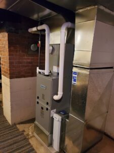 A newly installed furnace and air handler system with ductwork by Bouvy Heating & Air Conditioning Services in Pittsburgh, PA.