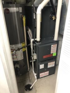 A new Goodman furnace and Rheem water heater installed in a utility closet by EPIC Heating and Air in Loveland, CO