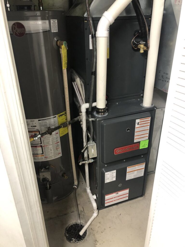 A new Goodman furnace and Rheem water heater installed in a utility closet by EPIC Heating and Air in Loveland, CO