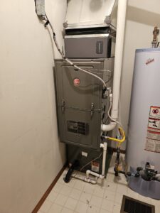 A newly installed furnace and water heater in a utility closet by High Efficiency HVAC in Nixa, MO.