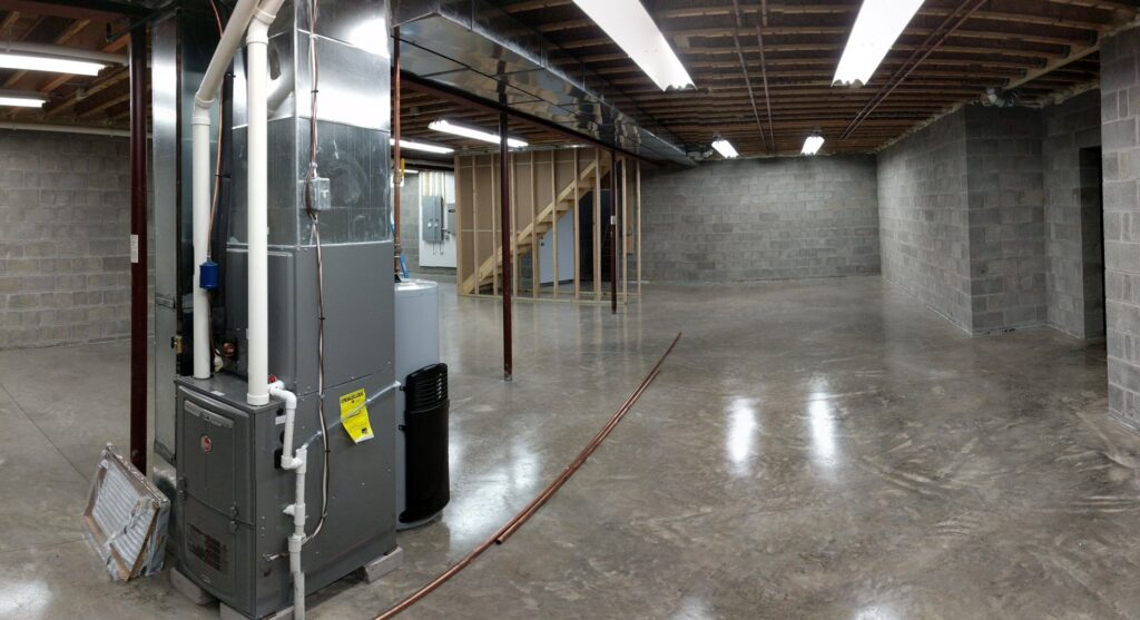 New furnace and ductwork installation in an unfinished basement by Huether Heating & Cooling Inc in Rochester, NY.