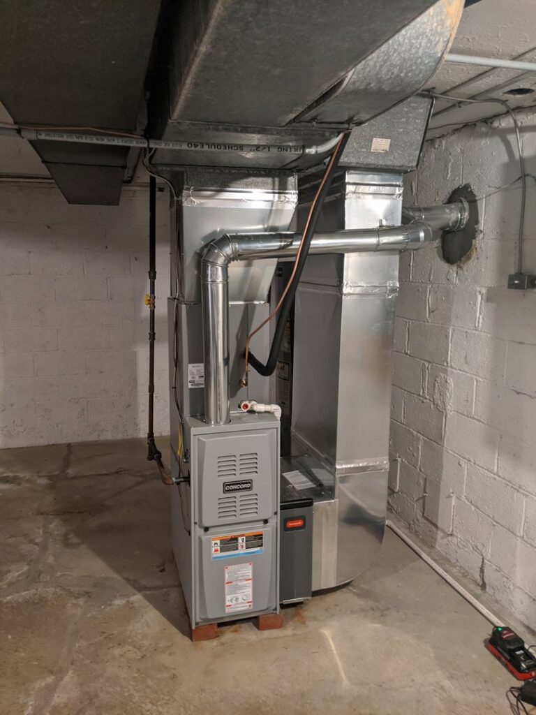 A newly installed furnace and HVAC system in a utility room by Collins Cooling and Heating in Cleveland, OH.