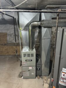 A newly installed furnace and ductwork in a basement by Ferreira Mechanical, LLC in Fall River, MA