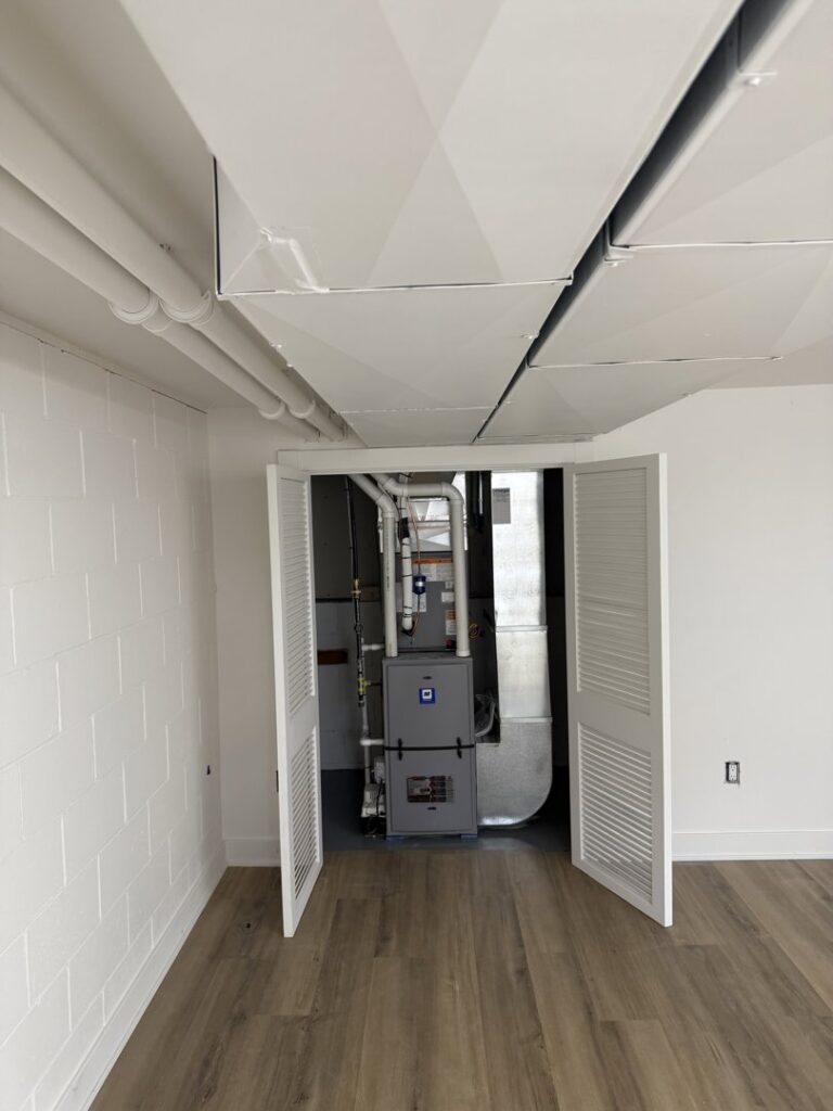 A newly installed furnace and ductwork system in a utility closet by Omega Air Solutions in West Des Moines, IA.