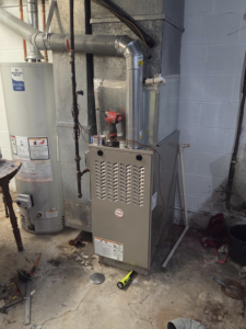 A new Rheem furnace being installed by Orchard Heating-Cooling and Sheet Metal in Stow, OH.