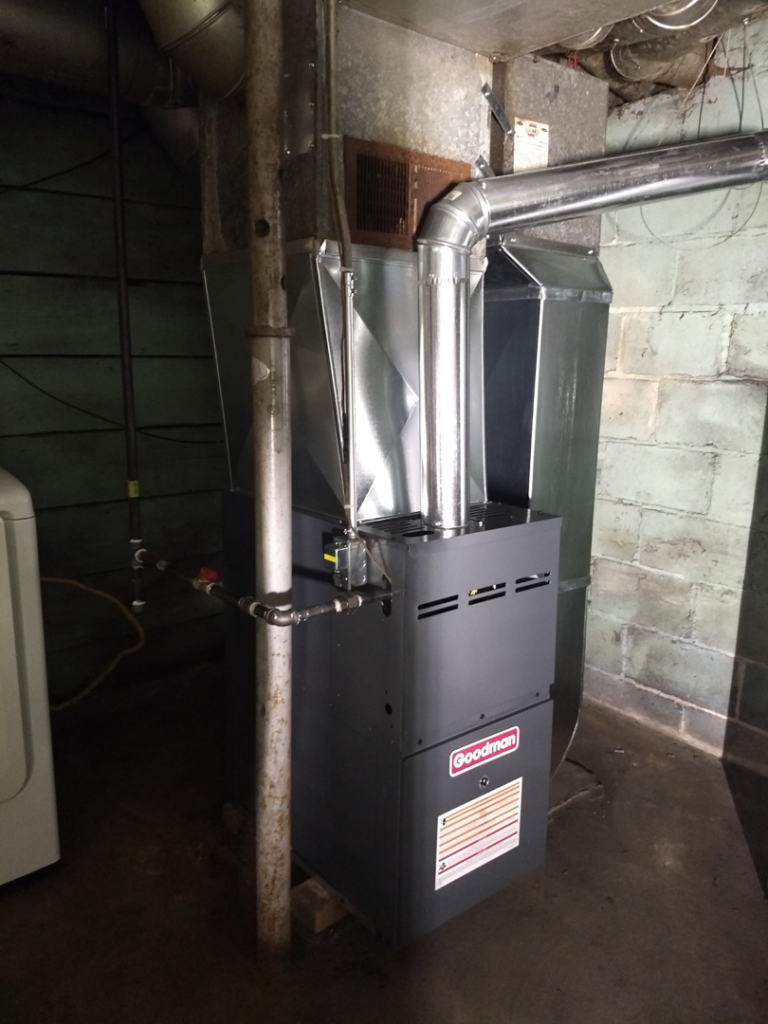 A new Goodman furnace installation with custom ductwork in a basement by PM Construction in Loves Park, IL.