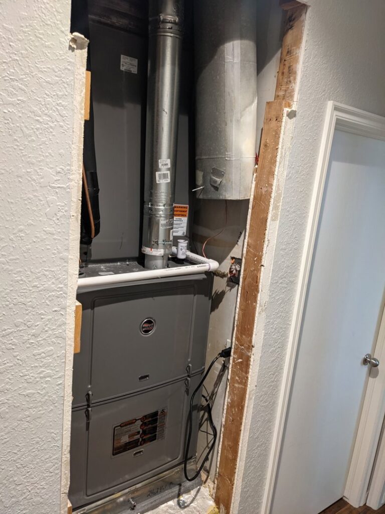 A newly installed furnace and air handler unit in a utility closet by Totality Heating And Cooling in Edmond, OK.