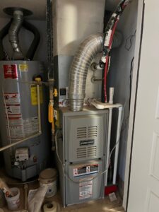 A newly installed Concord furnace and water heater in a utility closet by EA Heating & Cooling in El Paso, TX.