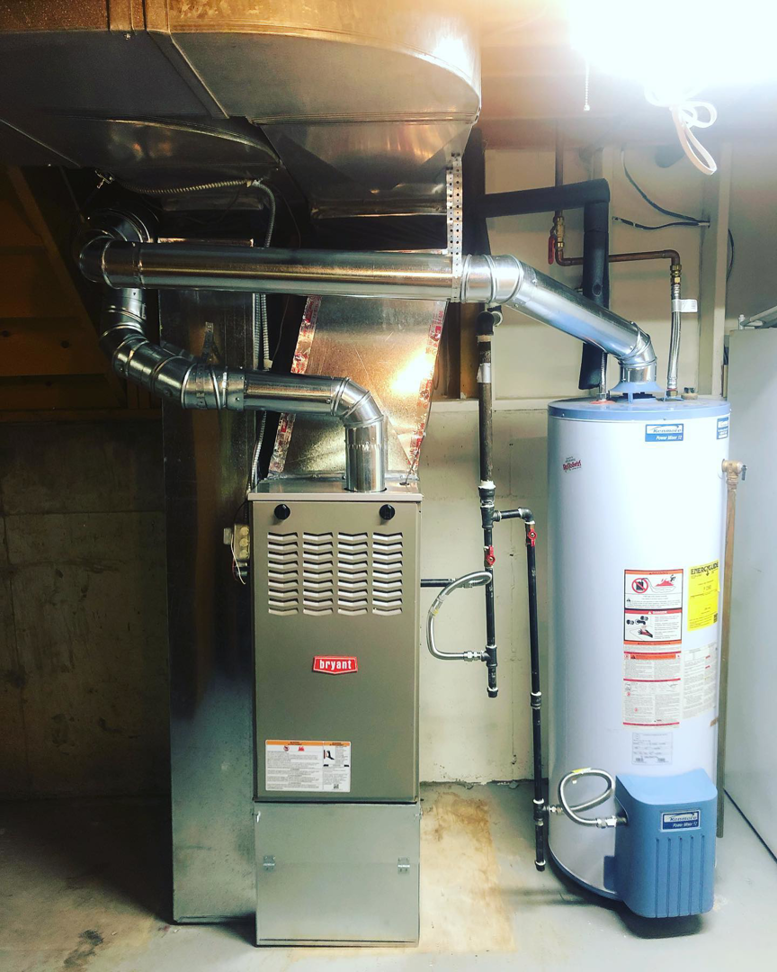 A newly installed Bryant furnace and water heater in a utility room by Excellence Heating & Air in Rohnert Park, CA
