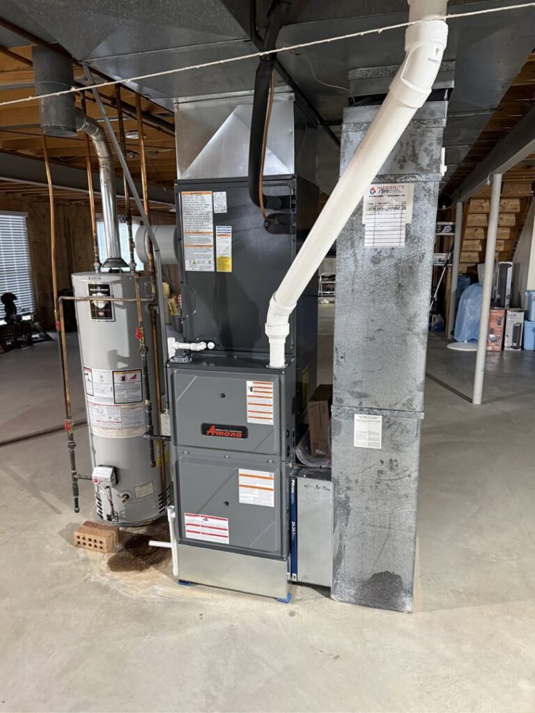 A newly installed furnace and water heater system in a basement by Integrity Aire in St. Charles, MO.