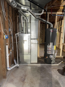 A newly installed furnace and water heater in a utility room by Nexus Heating & Air in Denver, CO.