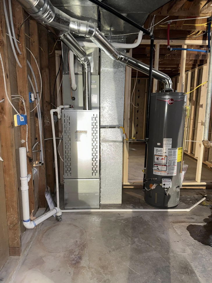 A newly installed furnace and water heater in a utility room by Nexus Heating & Air in Denver, CO.