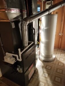 A newly installed furnace and water heater in a basement by Shook Heating And Cooling in Livonia, MI.