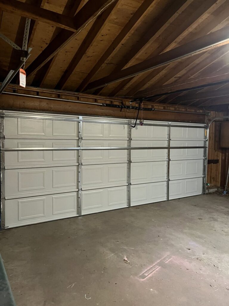 Interior view of a newly installed white garage door by The Region's Garage Door Repair in Hammond, IN.