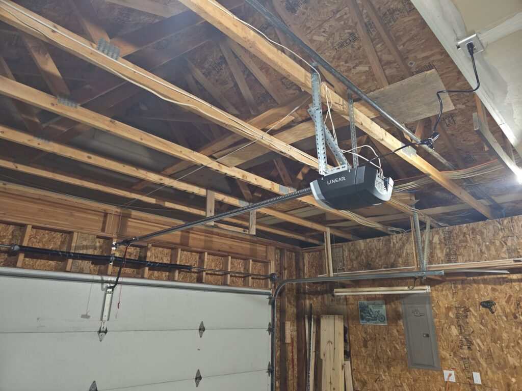 A newly installed garage door opener system visible from inside a garage by Garage Gecko in Spokane, WA.