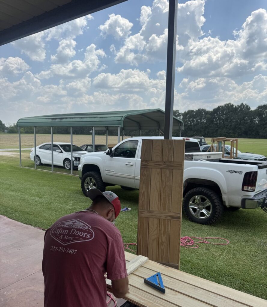 A hand holding a box of new garage door rollers, representing quality parts used by Cajun Doors & More in Lafayette, LA.