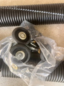 New garage door springs and rollers, essential parts for repair or installation, from 2BroGarage LLC in Charlotte, NC.