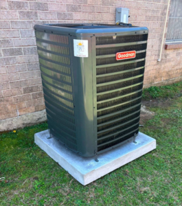 A newly installed Goodman outdoor AC condenser unit by Southern Heating & A/C LLC in Mobile, AL.