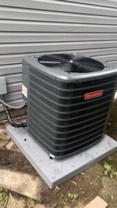 A new Goodman outdoor AC unit installed next to a house exterior by Buckeye Mechanical Construction in Columbus, OH.