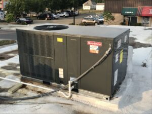 A newly installed Goodman commercial HVAC unit on a rooftop by Air Care Heating and Cooling Services in Shreveport, LA.