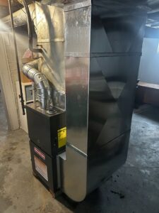 A newly installed Goodman furnace and associated ductwork in a basement by Family First Heating and Cooling Repair LLC in Toledo, OH.