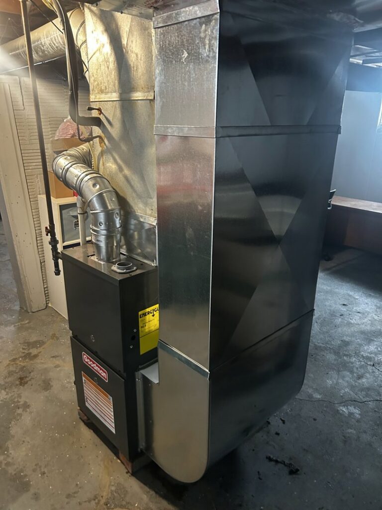 A newly installed Goodman furnace and associated ductwork in a basement by Family First Heating and Cooling Repair LLC in Toledo, OH.