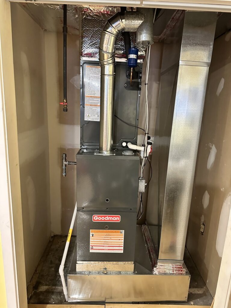A newly installed Goodman furnace and ductwork in a utility closet by Mueller Mechanical HVAC in Philadelphia, PA.