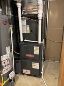 A new Goodman furnace and water heater installed in a utility room by Buckeye Mechanical Construction in Columbus, OH.