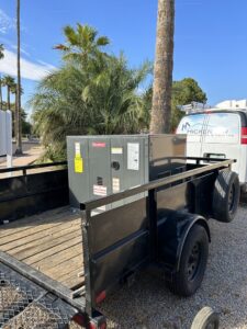 A new Goodman HVAC unit loaded on a trailer, ready for installation by Hicken Air in Gilbert, AZ