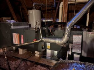 A newly installed Goodman HVAC unit and water heater in an attic by Grand Slam Heating & Air in Baton Rouge, LA.