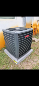 A new Goodman outdoor AC condenser unit installed on a concrete pad by AC All Stars AC contractor in Fort Lauderdale, FL.