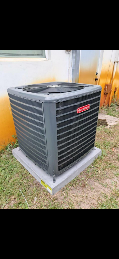 A new Goodman outdoor AC condenser unit installed on a concrete pad by AC All Stars AC contractor in Fort Lauderdale, FL.