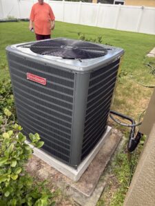 A newly installed Goodman outdoor AC unit in a residential backyard by Timely Air Conditioning in Riverview, FL.