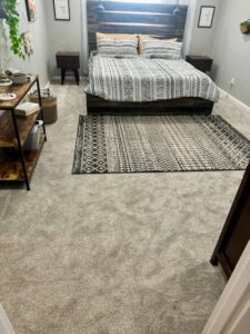 A bedroom featuring new gray carpet installed by Trent's Carpet Cleaning & Restoration in Fishers, IN.