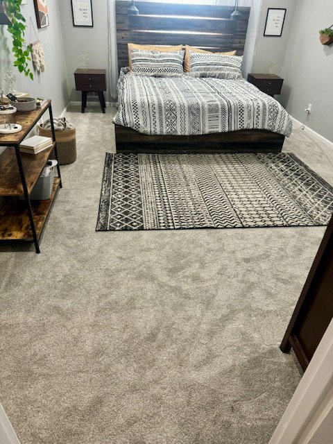 A bedroom featuring new gray carpet installed by Trent's Carpet Cleaning & Restoration in Fishers, IN.