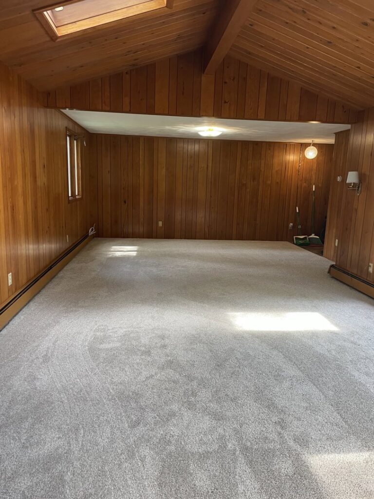 Freshly installed grey carpet in a spacious residential room by CAP Flooring in Buffalo, NY