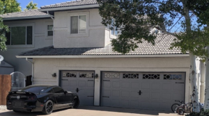 Newly installed grey carriage-style garage doors on a home by Southern Colorado Garage Door in Pueblo, CO.